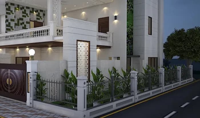 White villa boundary with a low wall, iron railings, planters and a decorative gate pillar at dusk