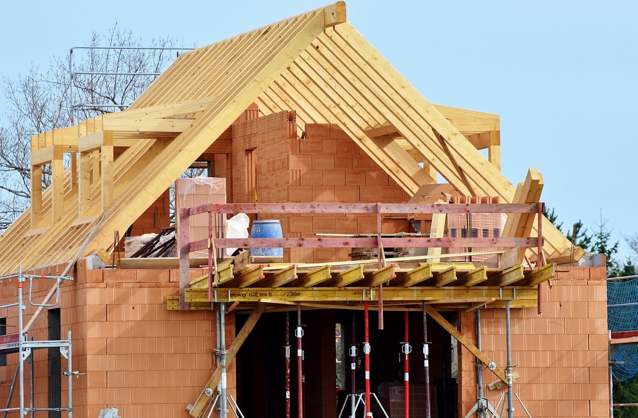 A residential building under construction showing steel framework and scaffolding